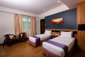 Postelja oz. postelje v sobi nastanitve Mariner Hotel Labuan