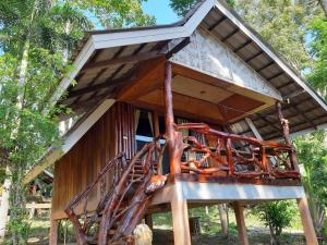 a tree house with a staircase in the middle at Activities Resort in Ko Yao Yai
