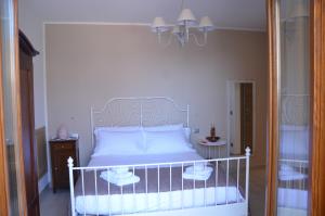 a bedroom with a white bed with two night stands at B&B LE TRE FATE in Varazze