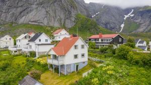 a group of houses in front of a mountain at House by the sea Reine, Lofoten in Reine