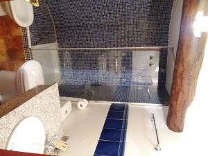 a bathroom with a sink and a toilet and a tub at Casa Torralba in El Frago