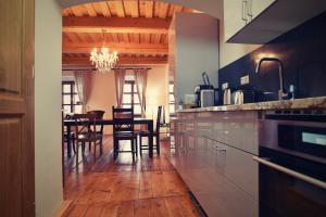 
a kitchen with wooden floors and wooden cabinets at Bed&Bike Prachatice in Prachatice

