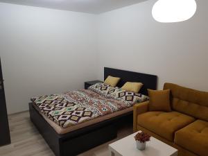 a bedroom with a bed and a couch at 1+1 Znojmo in Znojmo