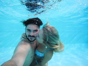 a man and a woman in the water at Residenza Principina in Principina Terra