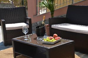 a table with a bottle of wine and a tray of fruit at B&B LE TRE FATE in Varazze