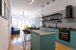 a kitchen with blue cabinets and a counter top at Luxury Penthouse on Akadimias with 2 Bed & 2 Bath in Athens