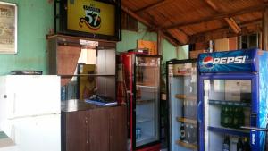 a room with two refrigerators and a pepsi machine at Palema Crown Hotel in Gulu