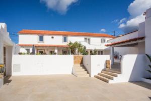 a white fence in front of a white house at SeaYa Villas in Cascais