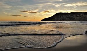 a sandy beach with the ocean and a sunset at Calpe Beach in Calpe