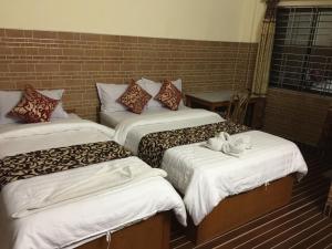 A bed or beds in a room at Lake Vision Guesthouse