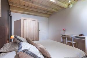 a bedroom with a bed with pillows on it at GÎTE DU PORCHE in Saint-Jean-de-la-Porte