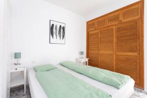 a bedroom with two beds and a wooden headboard at Casa Alcala in Alcalá