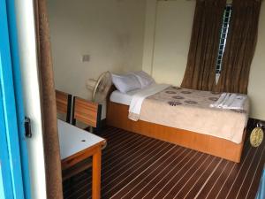 A bed or beds in a room at Lake Vision Guesthouse