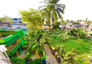 an overhead view of a city with palm trees at Dden Vennell BnB -Metro Access- in Kolkata