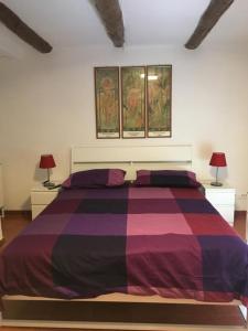 a bedroom with a large bed with two lamps at MIDA HOUSE in Naples
