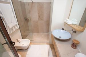 a bathroom with a shower and a sink and a toilet at La Sommità Relais & Chateaux in Ostuni