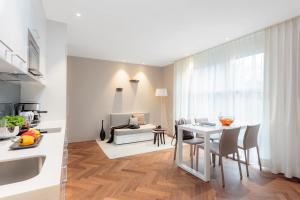 a kitchen and living room with a table and chairs at VISIONAPARTMENTS Bellariastrasse - self check-in in Zurich