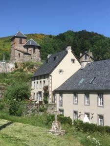 una casa blanca con un castillo en el fondo en DATCHA ANASTASIA, en Besse-et-Saint-Anastaise