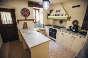 a kitchen with a counter top and a stove at Ellis Full Guest House in Tsagarada