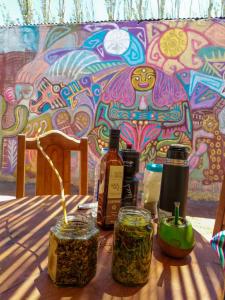 a table with two bottles of alcohol on a table at Hospedaje Familiar Raza Mistica in Villa Unión +183 photos