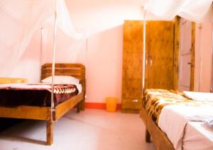 Okla GuestHouse في كامبالا: غرفة بسريرين في غرفة