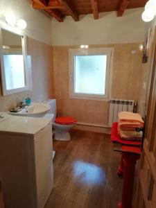 a bathroom with a sink and a toilet and a window at Los Castaños in Solana de ávila