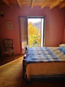 a bedroom with a bed and a large window at Los Castaños in Solana de ávila