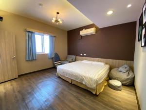 a bedroom with a bed and a chair in it at I WoW in Xiaoliuqiu