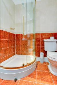 a bathroom with a tub and a toilet and a shower at The Ennerdale Country House Hotel ‘A Bespoke Hotel’ in Cleator