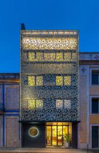 a building with a pattern on the side of it at The Convo Porto Hotel & Apartment in Porto