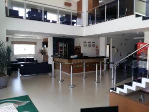 a living room with a couch and a table at Guines Palace Hotel in Patrocínio