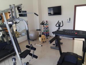 a room with a gym with a treadmill and weights at Guines Palace Hotel in Patrocínio