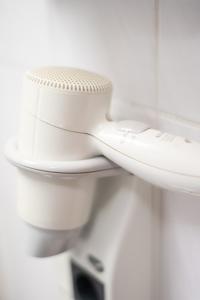 a close up of a white toilet in a bathroom at Taste Smart Hotel Lampertheim in Lampertheim