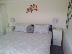 a bedroom with a bed and two night stands at Bacchus in Mevagissey