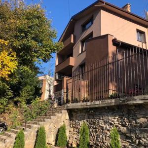 a building with a fence on top of a stone wall at Вила Мечта in Starozagorski Bani