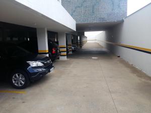 a parking lot with several cars parked in it at Guines Palace Hotel in Patrocínio