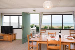 a dining room with a table and a view of the ocean at Cap Camerine in Cap d'Agde