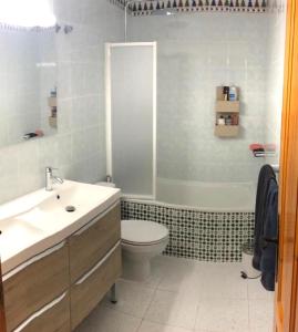 a bathroom with a sink and a toilet and a shower at ESPAGNE - ALICANTE - GUARDAMAR DEL SEGURA in Guardamar del Segura