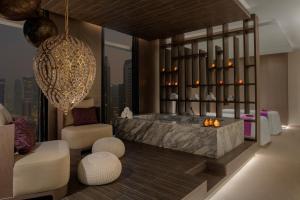 a rendering of a bathroom with a tub and a chair at Dusit Doha Hotel in Doha