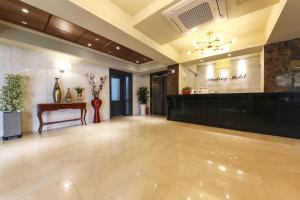 a large lobby with a table and a counter at Docking Hotel in Gimpo
