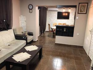 a living room with a couch and a table at Вила Мечта in Starozagorski Bani