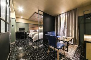 a hotel room with a bed and a table and a chair at Docking Hotel in Gimpo +57 photos