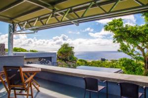 a view of the ocean from the balcony of a house at Hanalee Villa Kouri in Nakijin