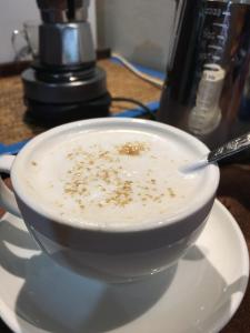 a bowl of soup on a plate with a spoon at Indy house59 in Bangkok