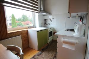 a small kitchen with a sink and a window at Dangus in Ramučiai