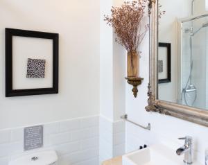 a bathroom with a sink and a mirror at Portuguese Charm in Lisbon in Lisbon +58 photos
