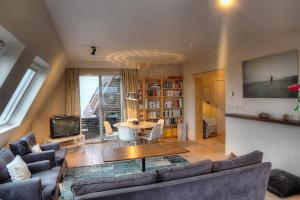 a living room with a couch and a table at Zoutezoute in Knokke-Heist