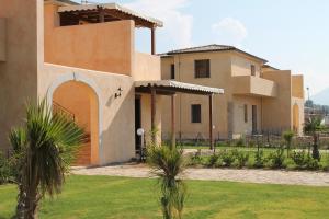 a house with a lawn in front of it at Campofelice Holidays in Campofelice di Roccella