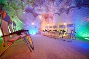 una fila de sillas en una habitación con luces de colores en Ośrodek Ukazia en Orzechowo