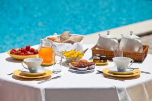 a table with a breakfast of fruit and juice at Solar Do Magoito in Sintra